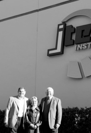 4th Generation Greg Jones with parents outside of Jones Technical Institute